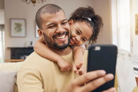 man-and-daughter-video-call-with-hola-health-online-doctor