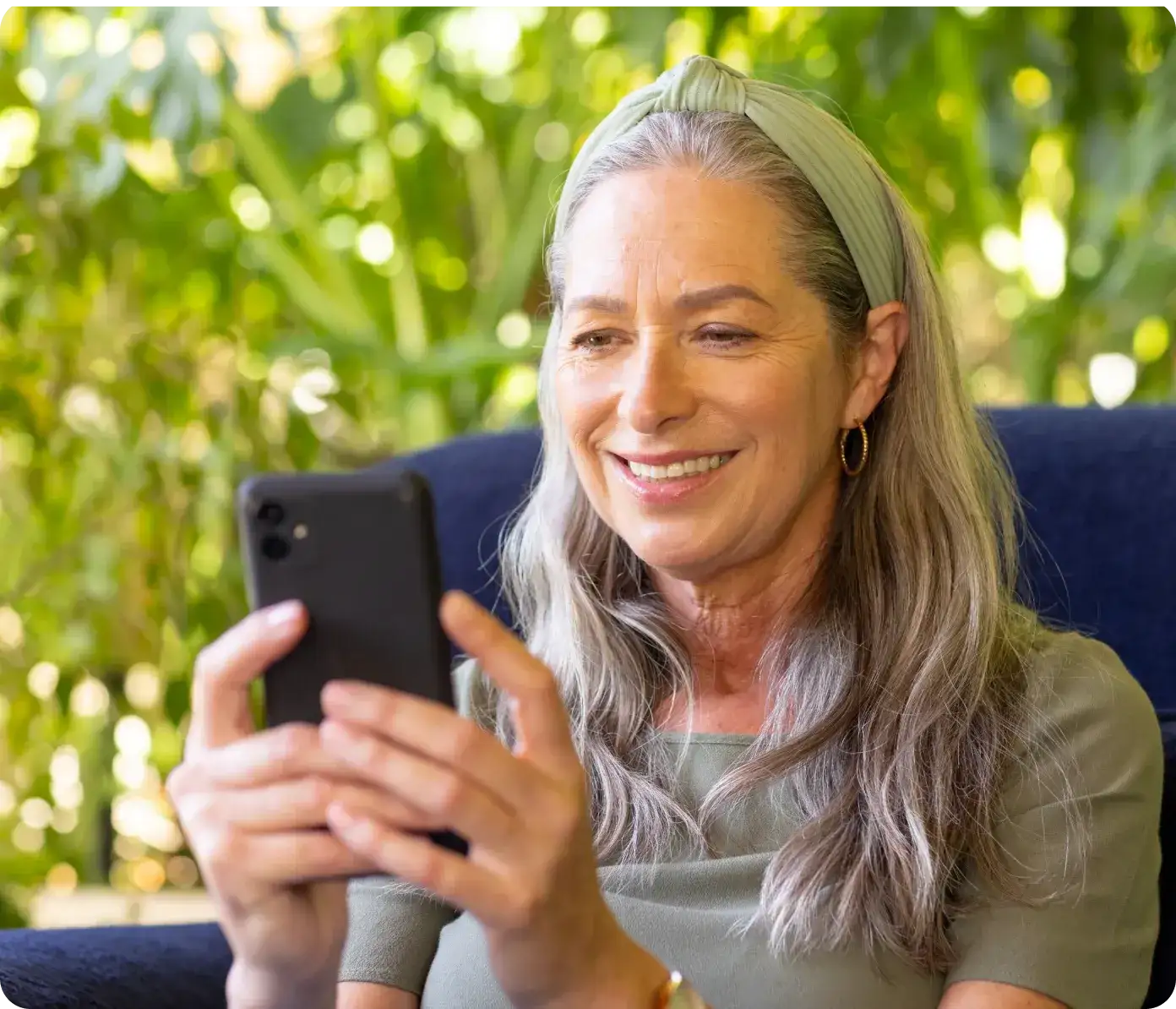 woman-happily-connecting-with-a-GP-online-through-Hola-Health-for-fast-safe-telehealth-support
